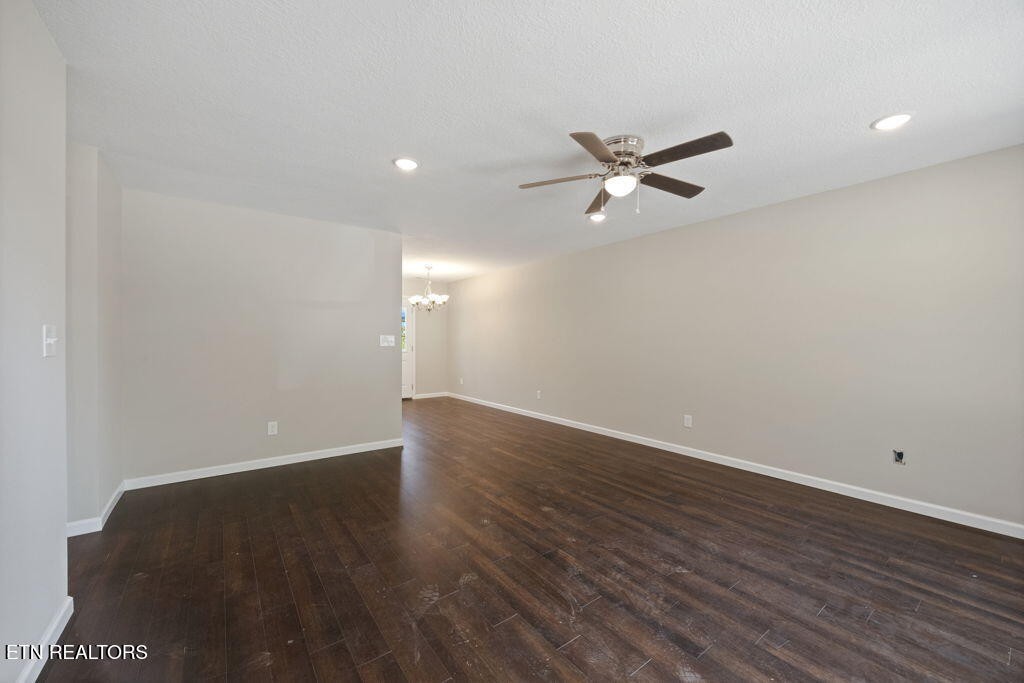 503 Hillcrest Street Clinton, TN 37716 - Photo 4 of 19 an empty room with wooden floor and fan