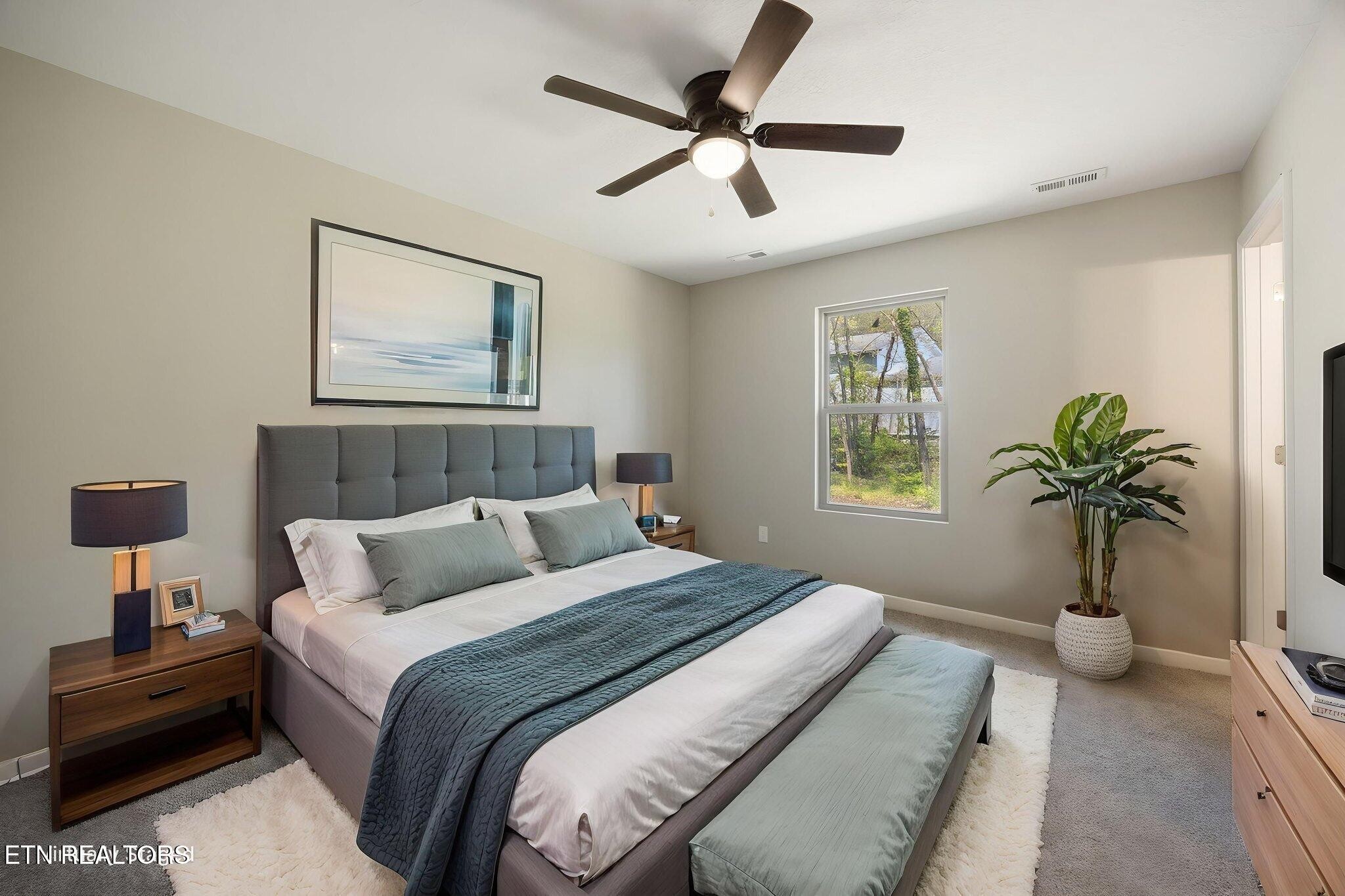 503 Hillcrest Street Clinton, TN 37716 - Photo 7 of 19 a bedroom with a bed and a potted plant