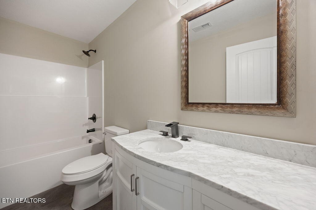 503 Hillcrest Street Clinton, TN 37716 - Photo 9 of 19 a bathroom with a sink toilet vanity and shower