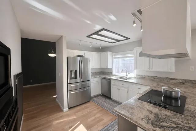 a kitchen with granite countertop stainless steel appliances and wooden cabinets