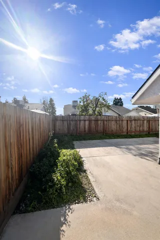a view of a garden with wooden fence