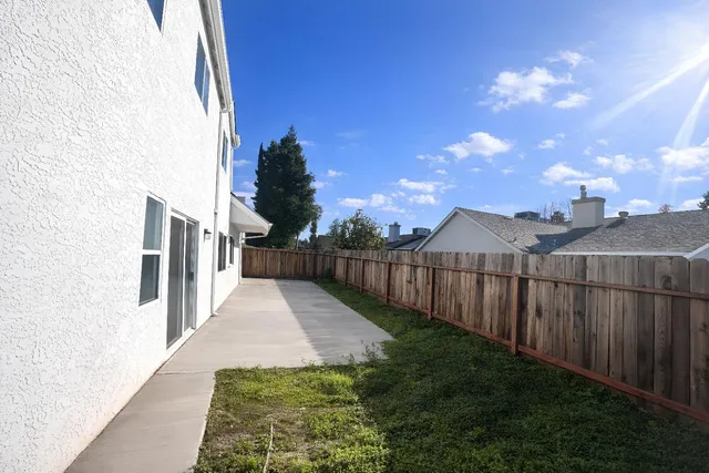 a view of a pathway with a wrought fence