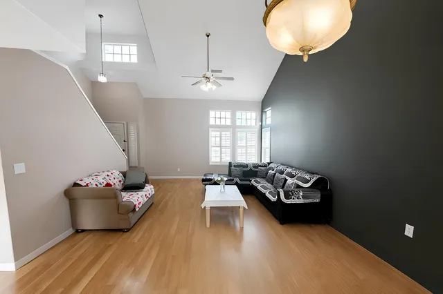 a living room with furniture chandelier and window