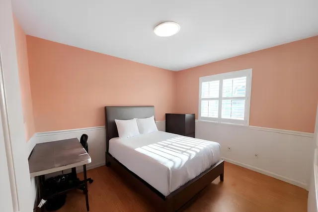 a bedroom with a bed and a window