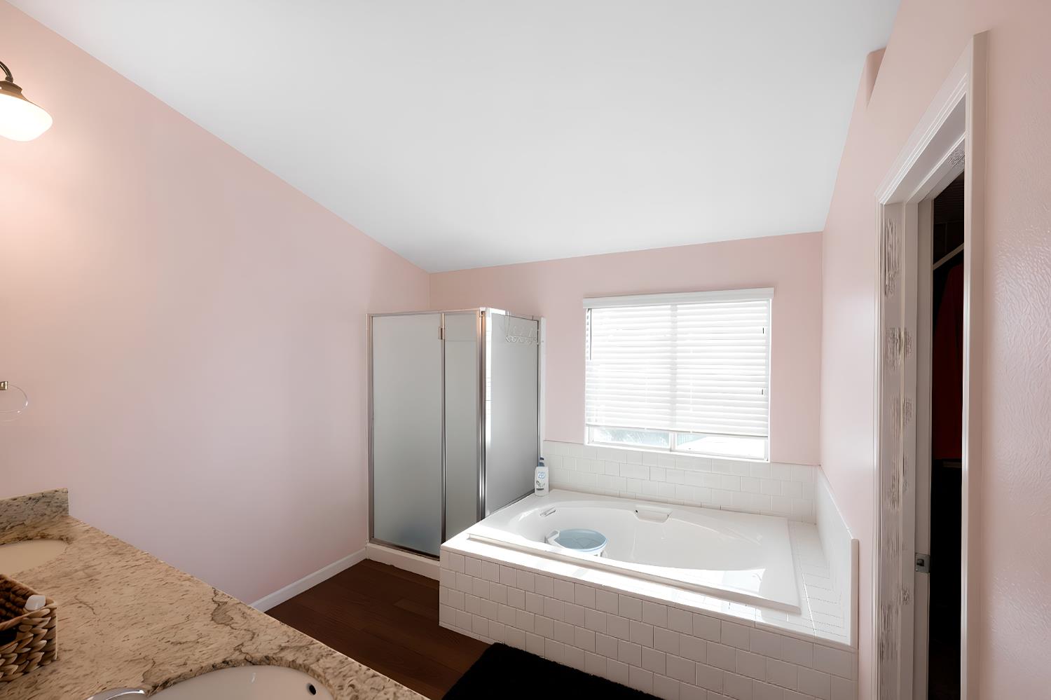 1815 East Frederick Avenue Fresno, CA 93720 - Photo 20 of 23 a bathroom with a bathtub and a window