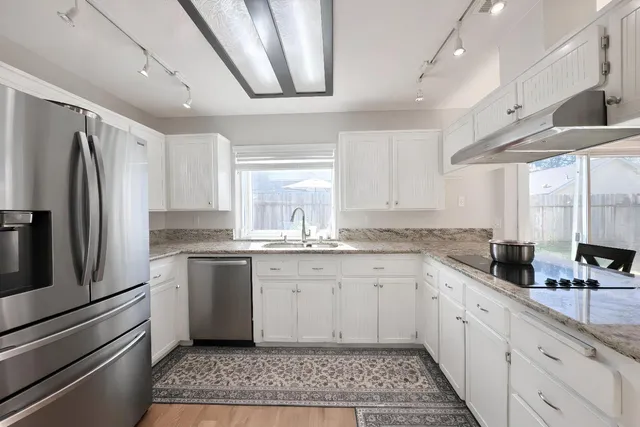 a kitchen with a sink stainless steel appliances and cabinets