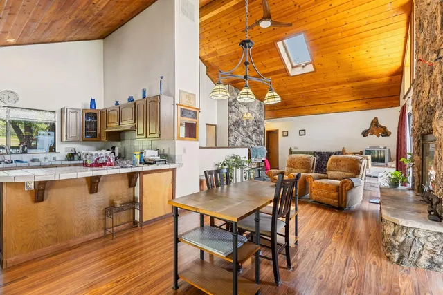 a bathroom with a granite countertop sink a toilet and shower