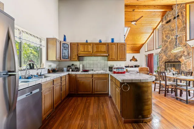 a bedroom with a bed a large window with table and chairs
