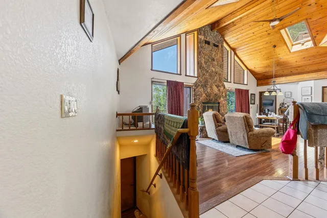 a spacious bedroom with a bed and wooden floor