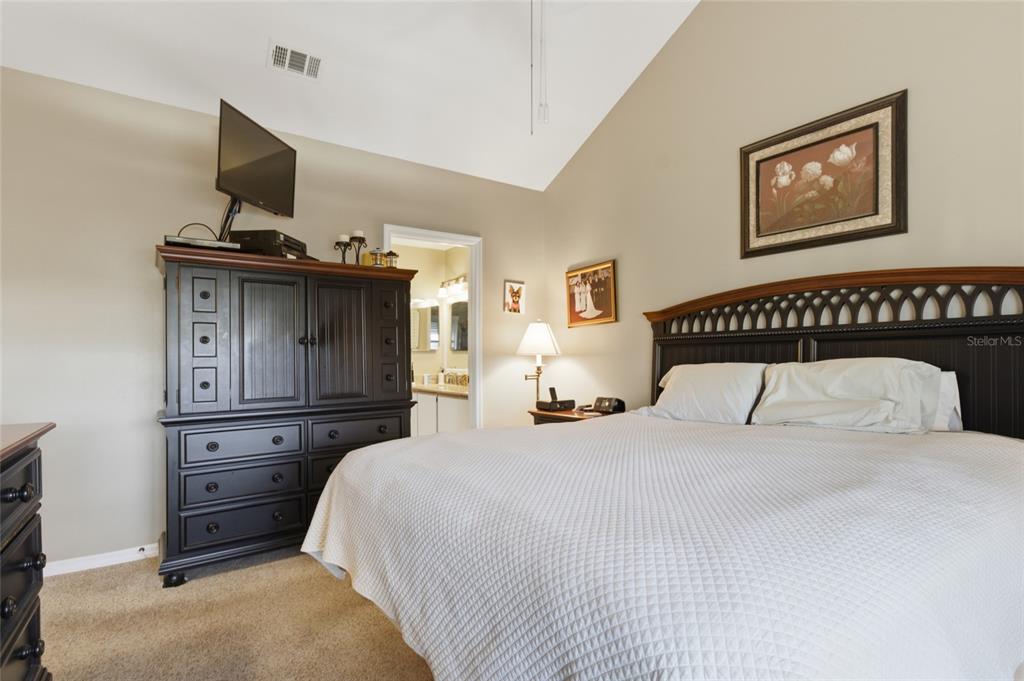5567 Sea Forest Drive, Unit 323 New Port Richey, FL 34652 - Photo 13 of 37 a bedroom with a bed and a television