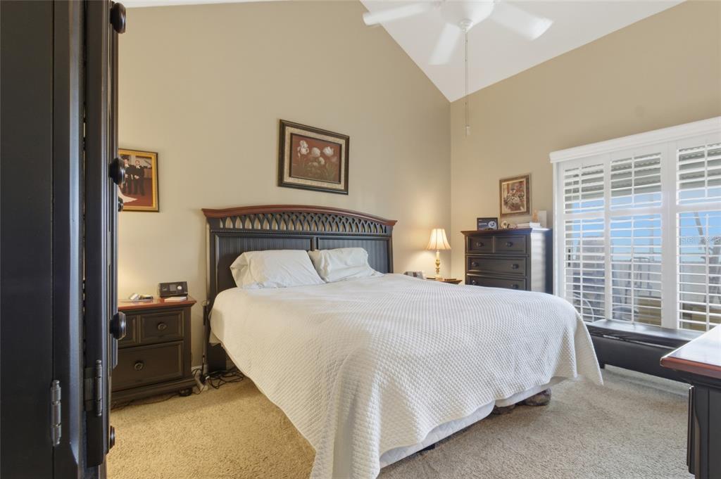 5567 Sea Forest Drive, Unit 323 New Port Richey, FL 34652 - Photo 14 of 37 a bedroom with a bed and a night stand