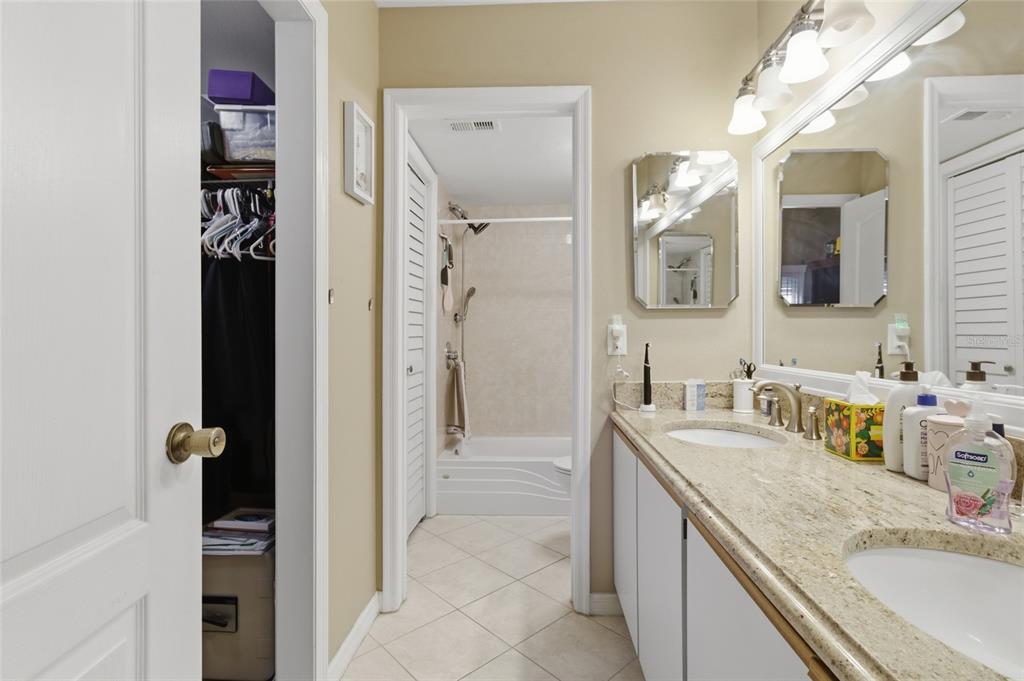 5567 Sea Forest Drive, Unit 323 New Port Richey, FL 34652 - Photo 15 of 37 a bathroom with a granite countertop sink vanity and mirror