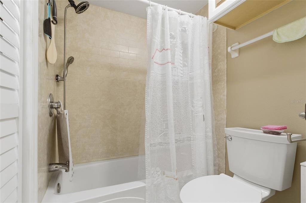 5567 Sea Forest Drive, Unit 323 New Port Richey, FL 34652 - Photo 17 of 37 a white toilet sitting next to a bath tub and shower