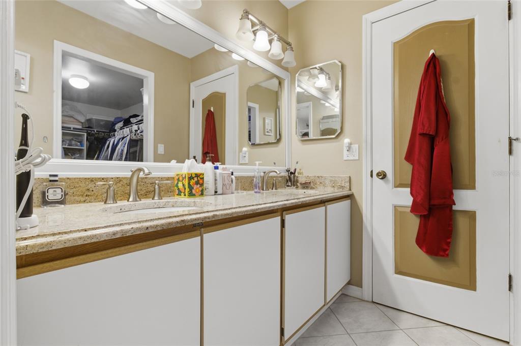 5567 Sea Forest Drive, Unit 323 New Port Richey, FL 34652 - Photo 18 of 37 a bathroom with a sink and a mirror