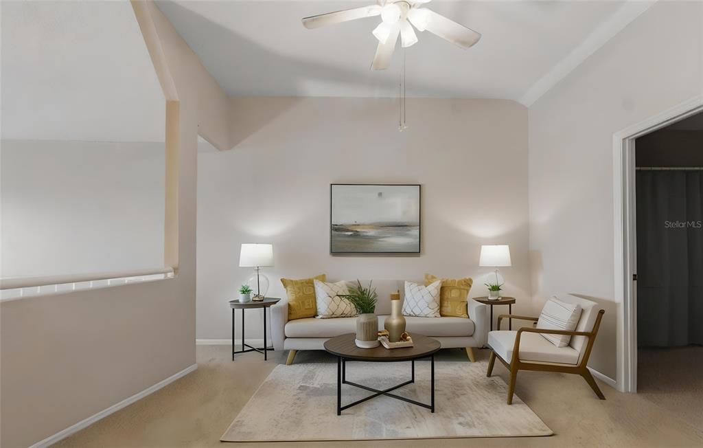 5567 Sea Forest Drive, Unit 323 New Port Richey, FL 34652 - Photo 27 of 37 a living room with furniture and a chandelier