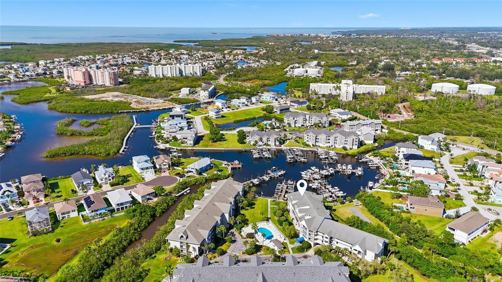 5567 Sea Forest Drive, Unit 323 New Port Richey, FL 34652 - Photo 3 of 37 an aerial view of a city with lots of residential buildings and ocean view in back