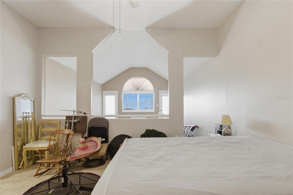 5567 Sea Forest Drive, Unit 323 New Port Richey, FL 34652 - Photo 31 of 37 a bedroom with furniture and a window