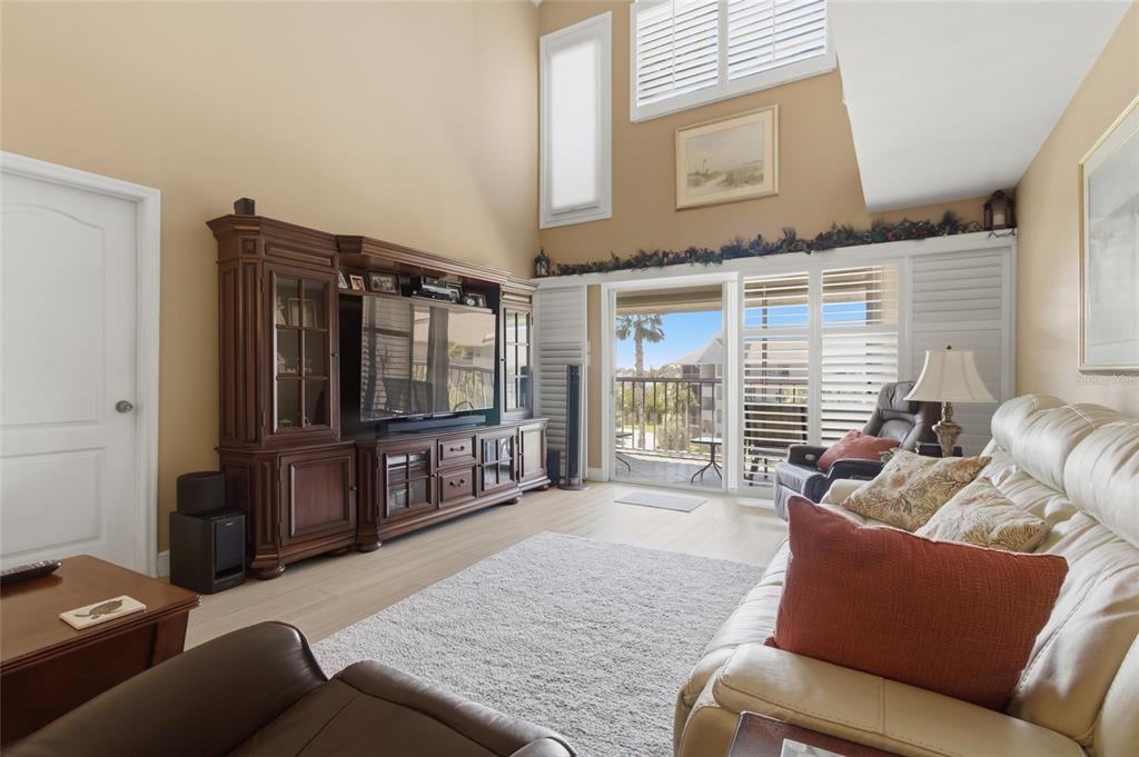 5567 Sea Forest Drive, Unit 323 New Port Richey, FL 34652 - Photo 7 of 37 a living room with furniture and a flat screen tv