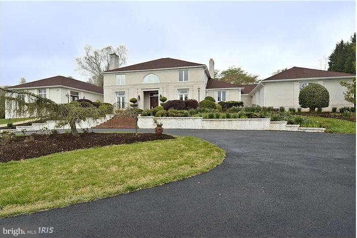 11505 Big Piney Way Potomac, MD 20854 - Photo 1 of 29 a front view of a house with a yard and potted plants