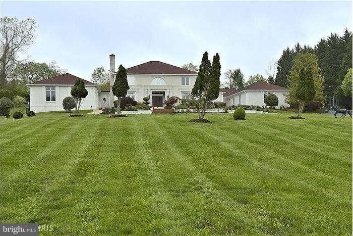 11505 Big Piney Way Potomac, MD 20854 - Photo 2 of 29 a front view of a house with a yard and trees