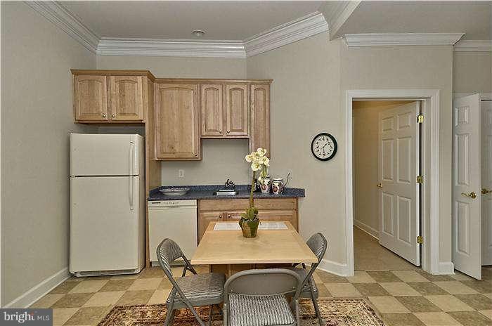 11505 Big Piney Way Potomac, MD 20854 - Photo 19 of 29 a kitchen with granite countertop a refrigerator a stove a sink and cabinets