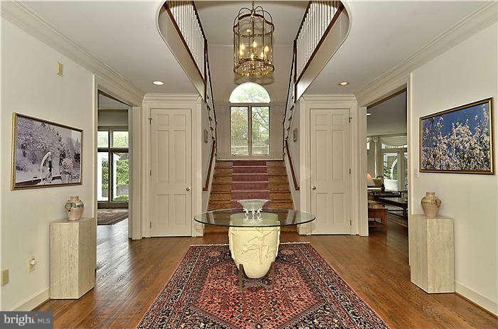 11505 Big Piney Way Potomac, MD 20854 - Photo 3 of 29 a hallway with wooden floor potted plant and windows