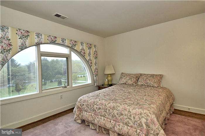 11505 Big Piney Way Potomac, MD 20854 - Photo 23 of 29 a large bed sitting in a bedroom next to a window