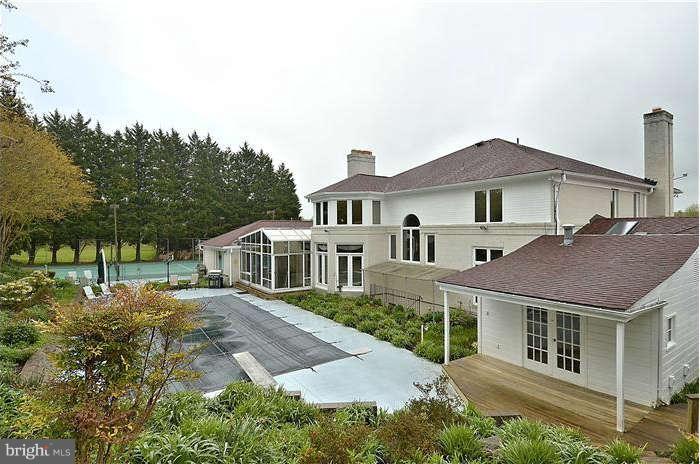 11505 Big Piney Way Potomac, MD 20854 - Photo 27 of 29 a front view of a house with a yard and potted plants