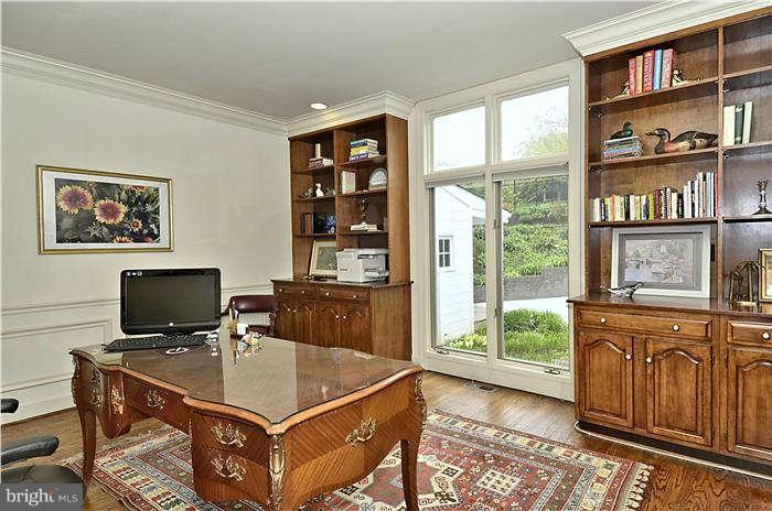 11505 Big Piney Way Potomac, MD 20854 - Photo 6 of 29 a view of a workspace with furniture and a bookshelf