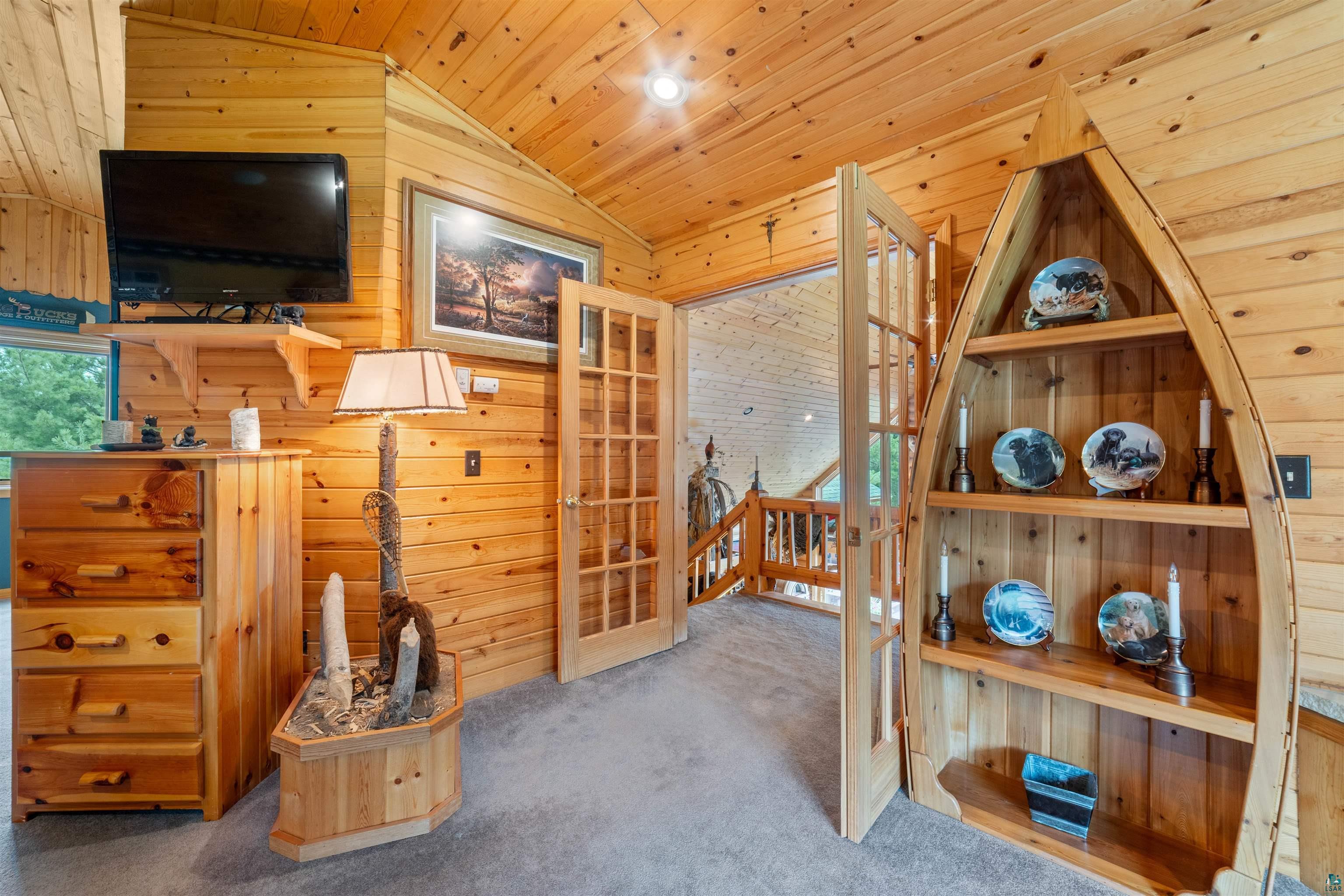11911 East Rowe Road Lake Nebagamon, WI 54849 - Photo 41 of 61 Interior space featuring extensive wood paneling and vaulted ceilings
