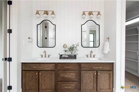 a bathroom with a double vanity sink and a mirror