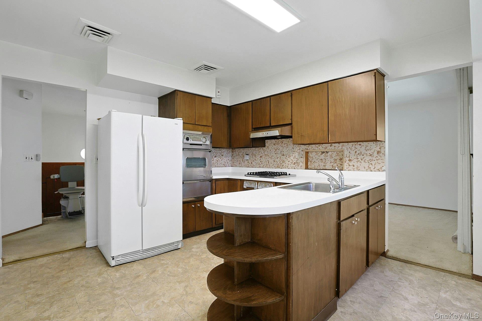 44 Southgate Drive Spring Valley, NY 10977 - Photo 8 of 24 a kitchen with a sink and a refrigerator