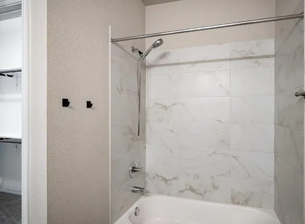 a bathroom with a shower and a bath tub