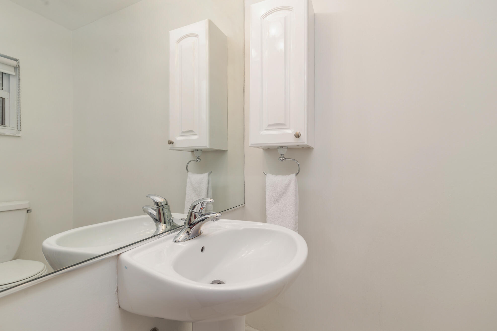 248 Cortez Road West Palm Beach, FL 33405 - Photo 18 of 27 a bathroom with a sink a toilet and a mirror
