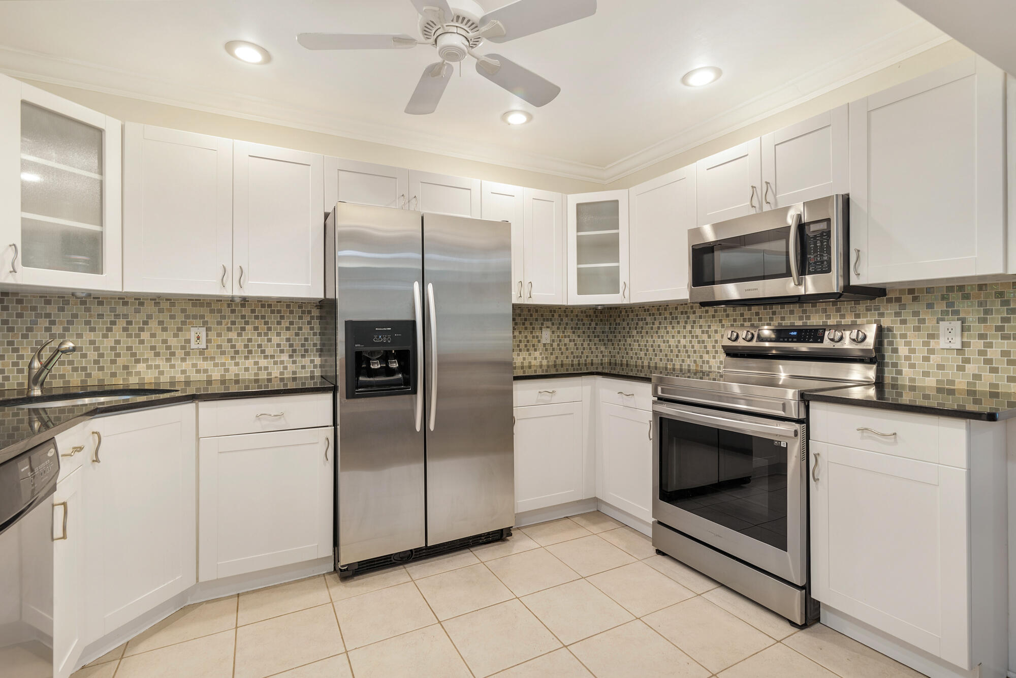 248 Cortez Road West Palm Beach, FL 33405 - Photo 8 of 27 a kitchen with stainless steel appliances granite countertop a refrigerator a stove a sink and white cabinets