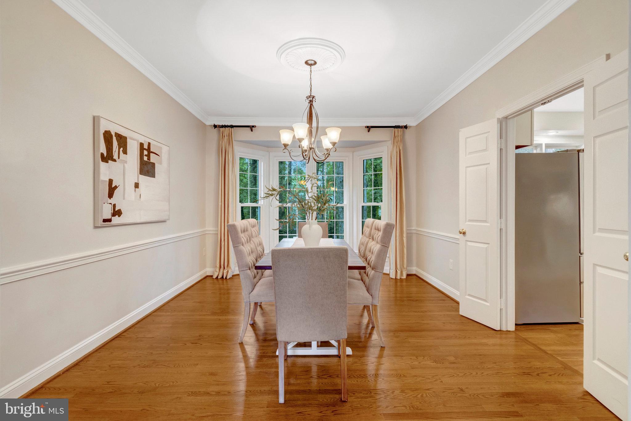 11181 Longwood Grove Drive Reston, VA 20194 - Photo 13 of 94 a view of a dining room with furniture window and wooden floor