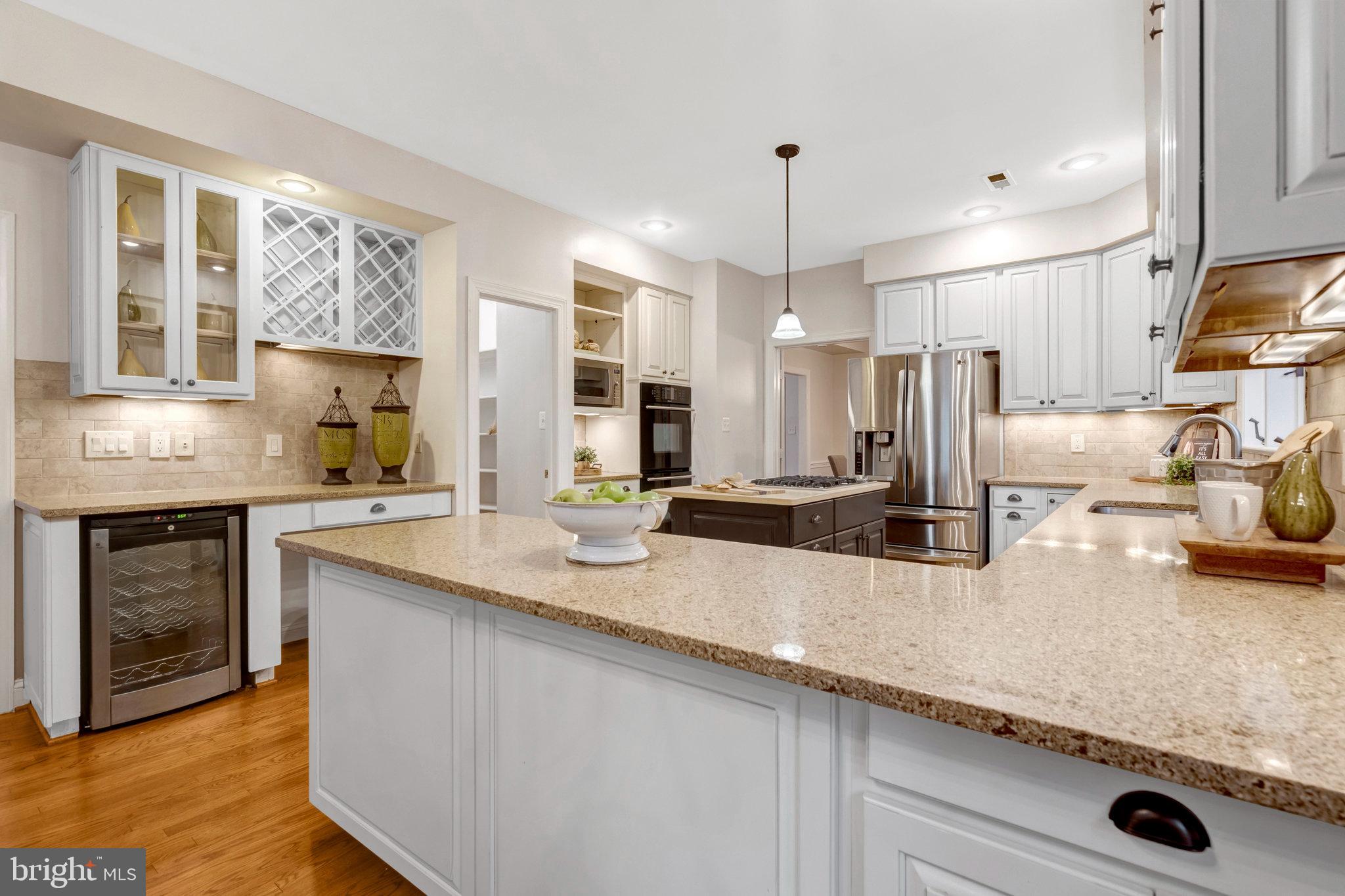 11181 Longwood Grove Drive Reston, VA 20194 - Photo 21 of 94 a kitchen with stainless steel appliances granite countertop a sink a stove and a refrigerator