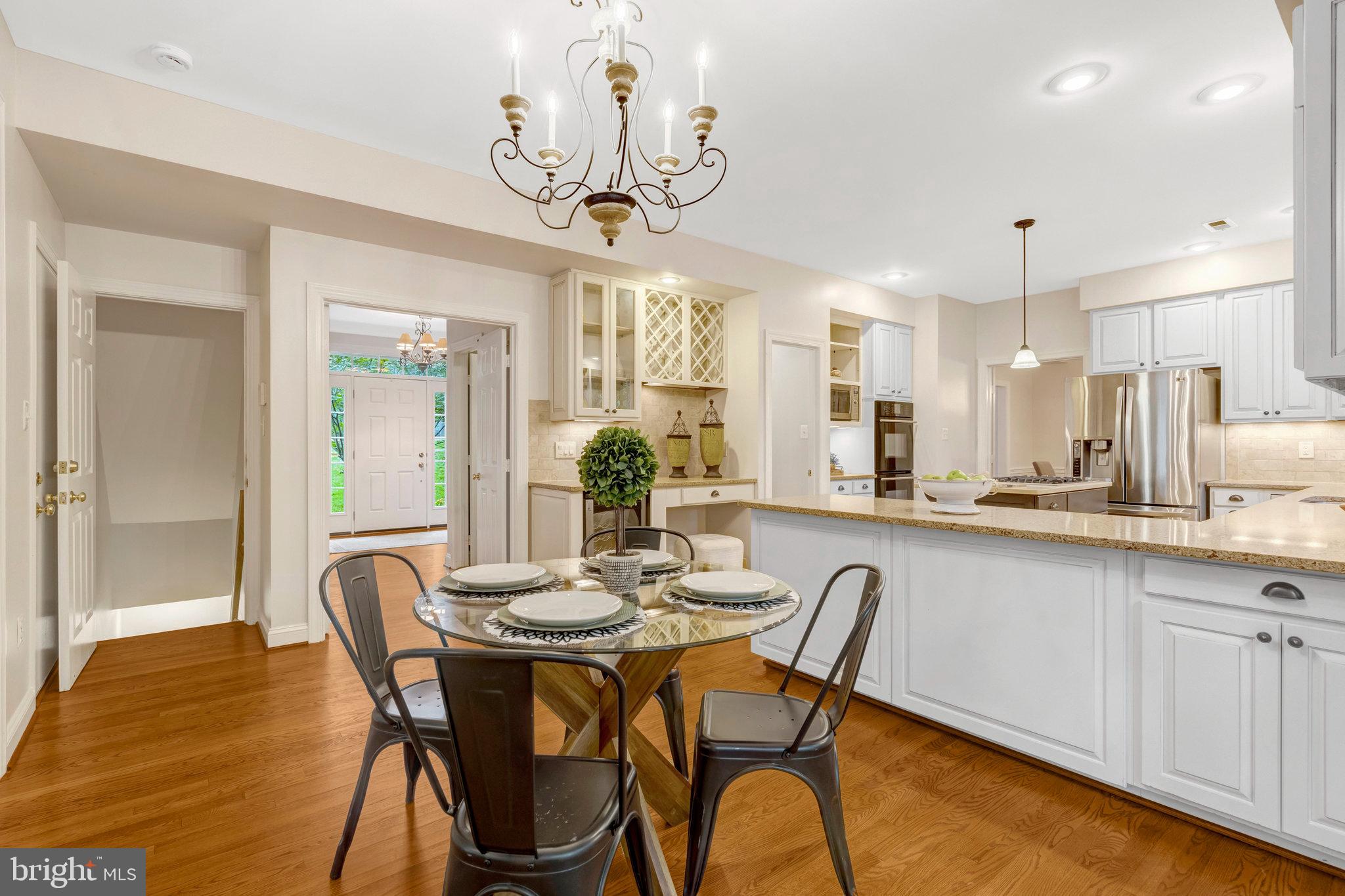 11181 Longwood Grove Drive Reston, VA 20194 - Photo 24 of 94 a dining room filled chandelier and wooden floor