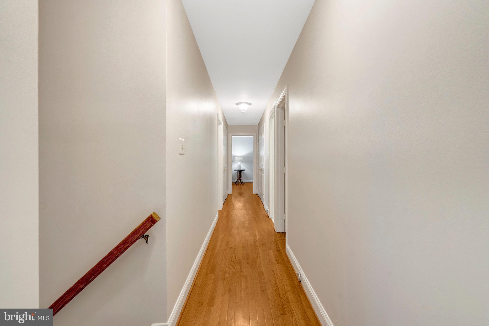 11181 Longwood Grove Drive Reston, VA 20194 - Photo 31 of 94 a view of a hallway with wooden floor and staircase