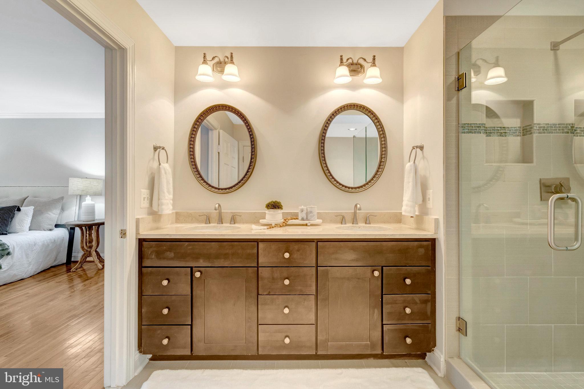 11181 Longwood Grove Drive Reston, VA 20194 - Photo 46 of 94 a bathroom with a granite countertop double vanity sink and a mirror