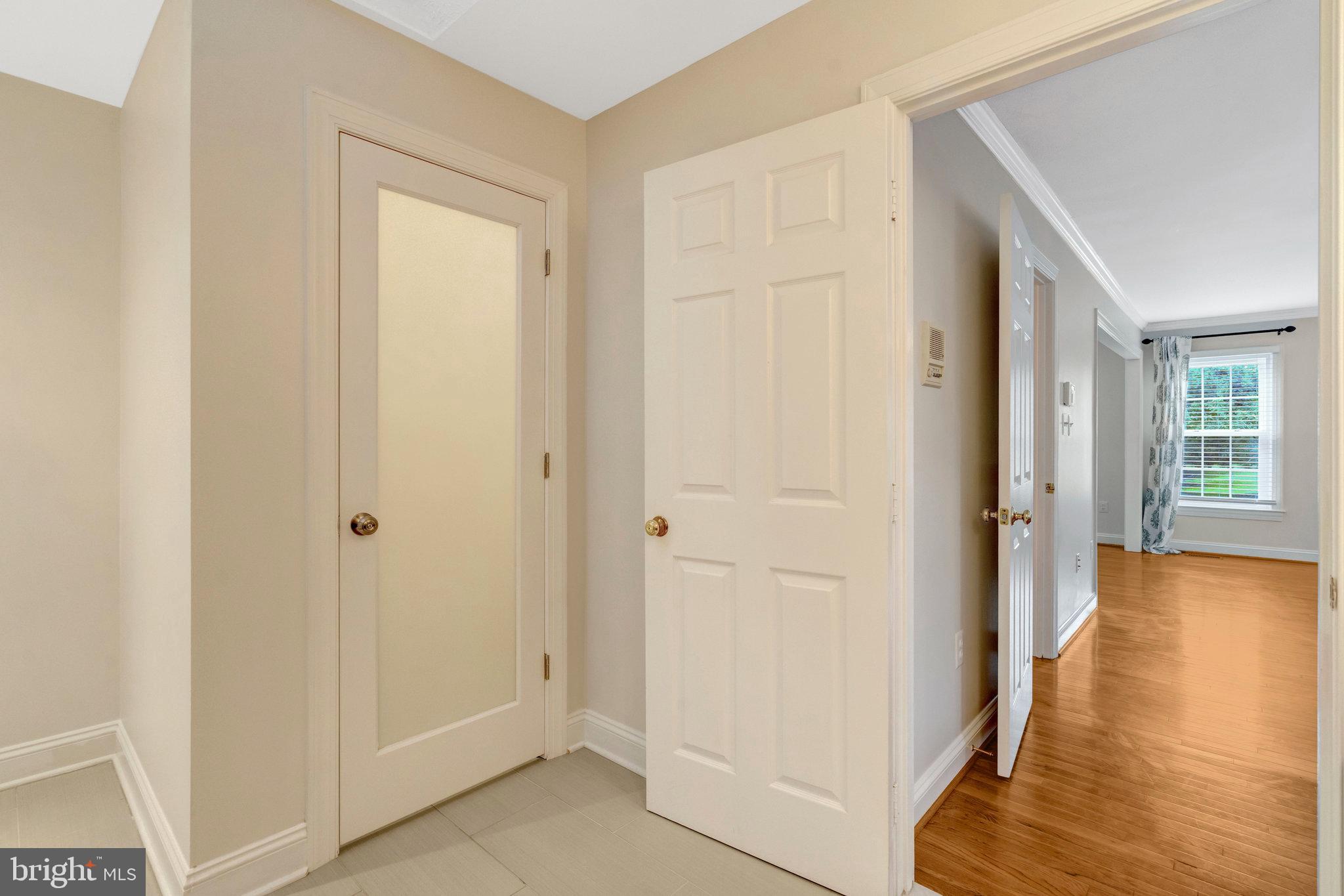 11181 Longwood Grove Drive Reston, VA 20194 - Photo 47 of 94 a view of a hallway with wooden floor and entryway
