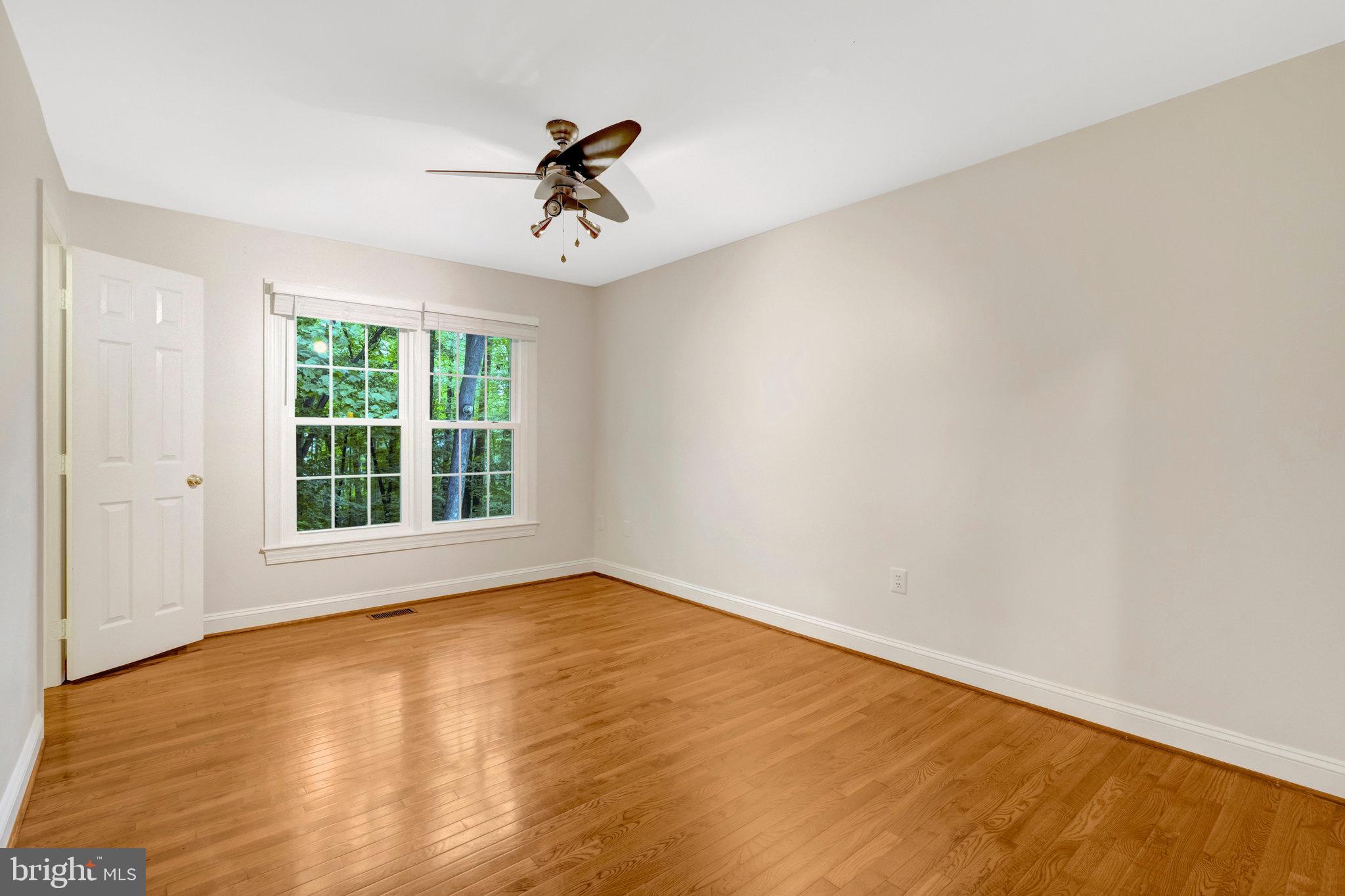 11181 Longwood Grove Drive Reston, VA 20194 - Photo 52 of 94 a view of an empty room with a window and a ceiling fan