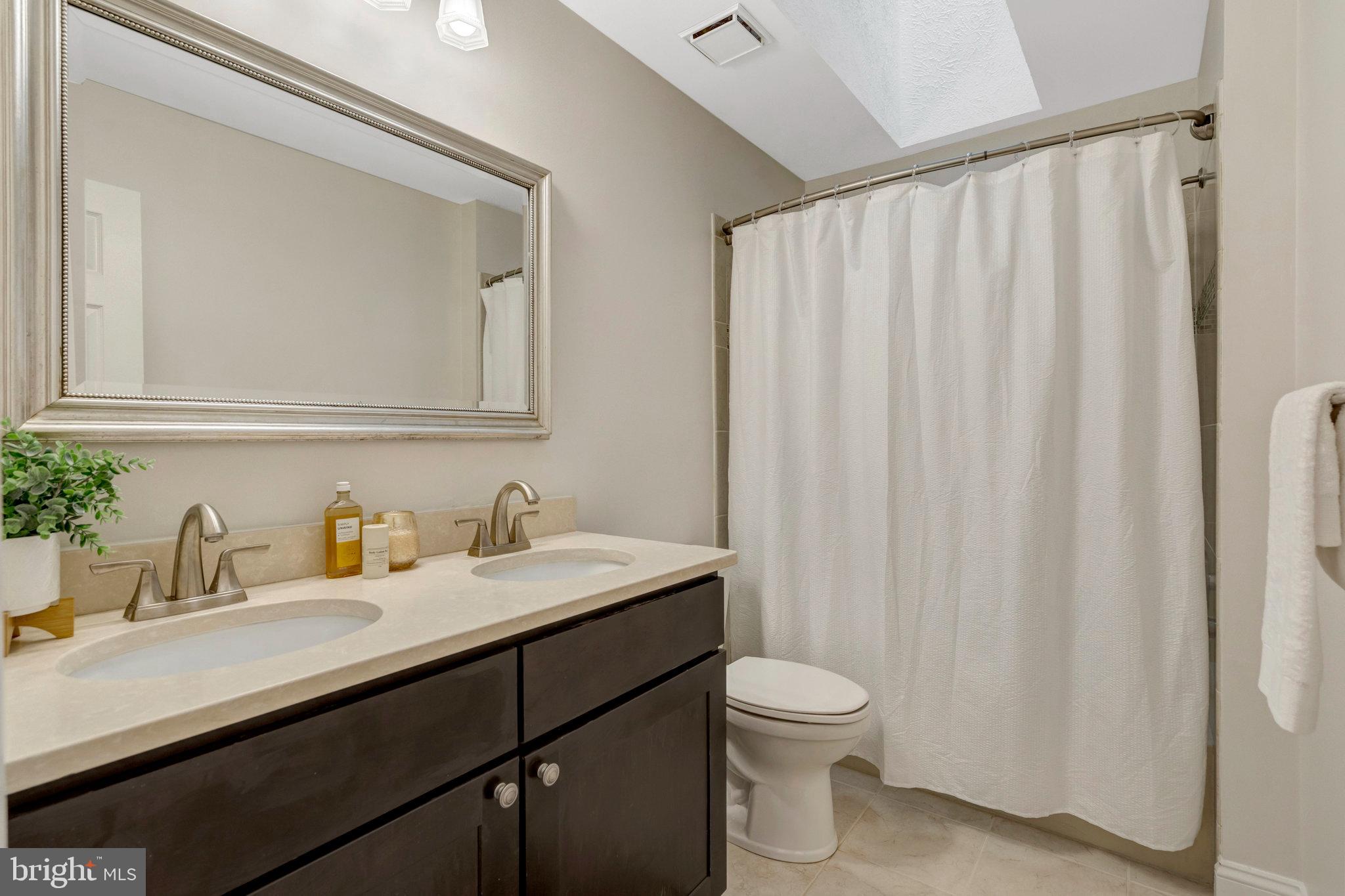 11181 Longwood Grove Drive Reston, VA 20194 - Photo 54 of 94 a bathroom with a granite countertop sink and a toilet