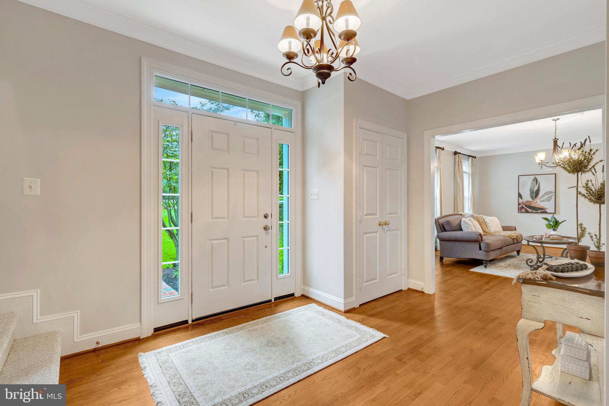 11181 Longwood Grove Drive Reston, VA 20194 - Photo 6 of 94 a living room with furniture and a chandelier