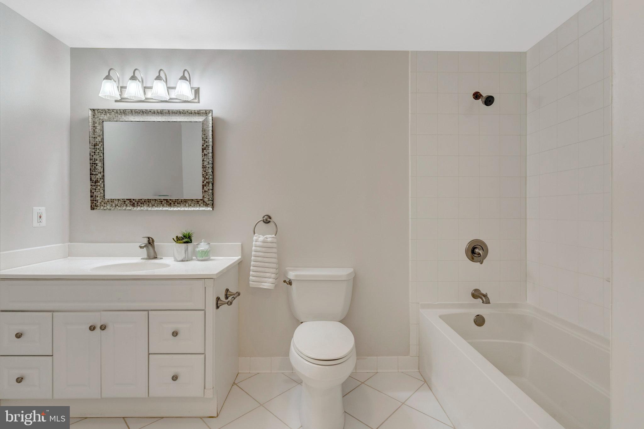 11181 Longwood Grove Drive Reston, VA 20194 - Photo 73 of 94 a bathroom with a toilet a sink a tub and mirror