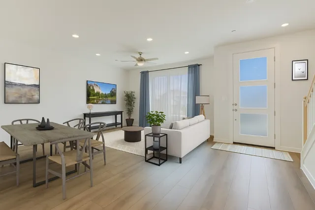 a living room with furniture and a wooden floor