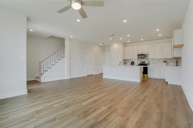 a view of kitchen with wooden floor and electronic appliances