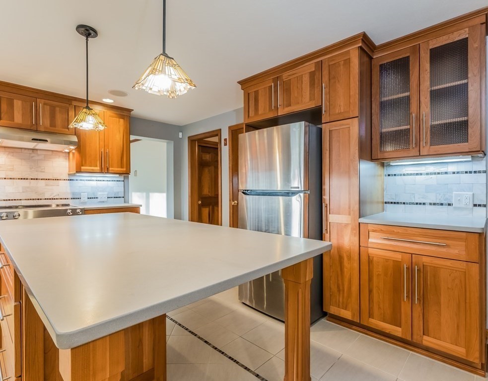 4 Uplands Road Littleton, MA 01460 - Photo 13 of 39 a kitchen with stainless steel appliances a refrigerator and a stove