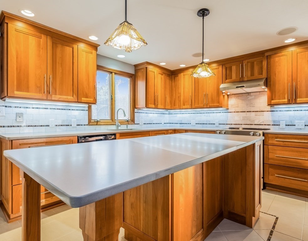 4 Uplands Road Littleton, MA 01460 - Photo 9 of 39 a kitchen with stainless steel appliances granite countertop a sink a stove and a wooden cabinets