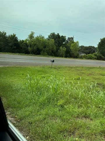 a view of a green field with clear sky